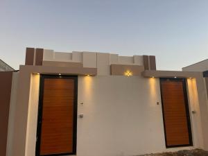 two doors on the side of a building at AL Rabie Villa, Nizwa Grand Mall in Firq