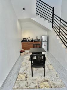 a table and chair in a kitchen with a staircase at AL Rabie Villa, Nizwa Grand Mall in Firq