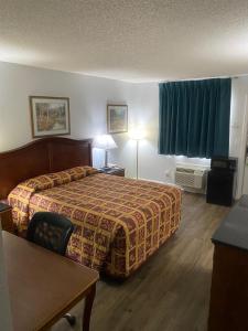 Habitación de hotel con cama, mesa y escritorio. en Savannah Lodge, en Savannah