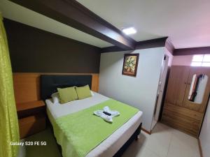 a bedroom with a bed with a towel on it at Hostal America in Calama