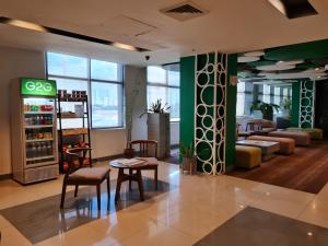 Go Hotels Otis - Manila في مانيلا: غرفة بها كراسي وطاولات في متجر