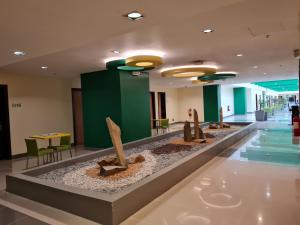 a lobby with a display of sculptures on the floor at Go Hotels Otis - Manila in Manila