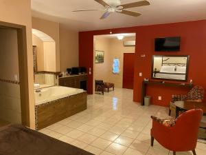 a large bathroom with a tub and a tv at Hotel & Eventos Xalos in Jalostotitlán