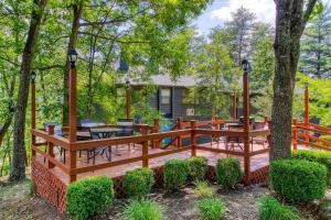 a wooden deck in the middle of a yard with trees at Pool-Pinecrest Townhomes-1King-2Queen Unit-Renovated in Pigeon Forge