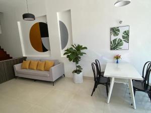 a living room with a couch and a table at Lis Hotel in Danang