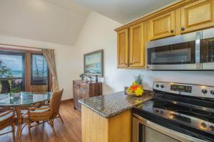 a kitchen with a table and a counter top at Kaha Lani 304 in Lihue