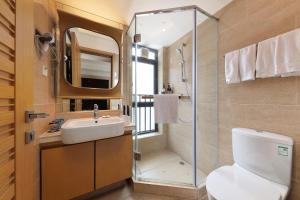a bathroom with a toilet and a sink and a shower at East Maple International Apartment - Guangzhou International Financial City Keyun Road Metro Station in Guangzhou