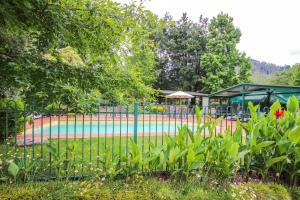 a playground in a park with a fence and flowers at Silver Birches Holiday Village - Unit 2 in Bright