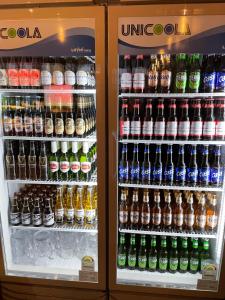 a refrigerator filled with lots of bottles of soda at Doobaki Hostel in Gyeongju