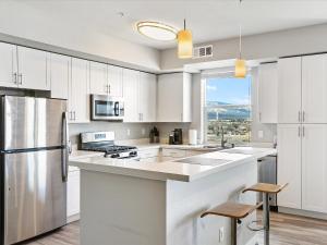 a kitchen with white cabinets and a large window at Exquisite Lakefront Condo in Sparks