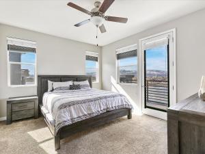 a bedroom with a bed and a ceiling fan at Exquisite Lakefront Condo in Sparks