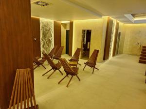 a row of wooden chairs in a room at Binis in Zlatibor