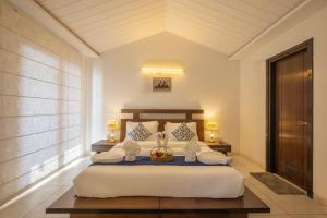 a bedroom with a bed with a bowl of fruit on it at The Trident I Kasauli by Humble stay villa in Kasauli