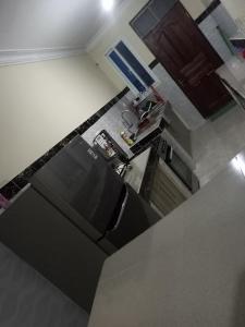 een keuken met een koelkast bij Lizzy B Classic Apartments Mtwapa in Mombasa