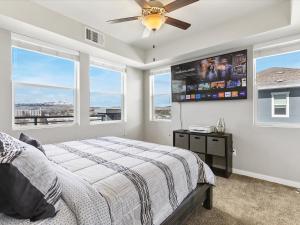 a bedroom with a bed and a flat screen tv at Exquisite Lakefront Condo in Sparks