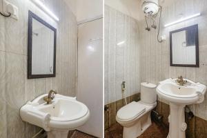 a bathroom with a sink and a toilet and a mirror at FabHotel Corporate Stay in Noida