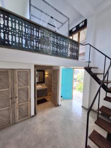a staircase in a house with a kitchen and a living room at Temptation in Hikkaduwa