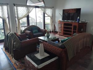 a living room with two couches and a television at Luxury front sea private villa, 3 bedroom on the bang po beach Maenam ,ko Samui in Ban Bang Po
