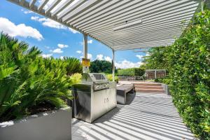 a covered walkway with a trash can and plants at 1-Bed with Amazing Views, Pool, Gym, BBQ & Parking in Canberra