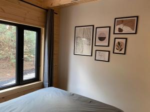 a bedroom with a bed and pictures on the wall at Duża Holenderka - Lewy Brzeg Narwi in Burlaki