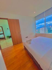 a bedroom with a large bed and a large window at vortex klcc RR in Kuala Lumpur
