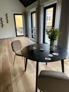 una mesa negra y sillas en la sala de estar. en Kallehavegaard Badehotel en Løkken