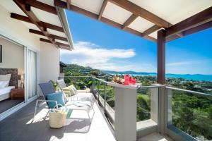 a balcony with a view of the mountains at Oscar's View - Airlie Beach in Airlie Beach