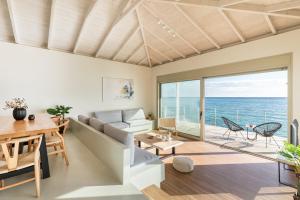a living room with a view of the ocean at Melivia Seafront Resort in Nea Skioni