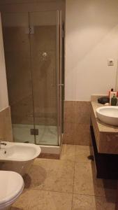 a bathroom with a shower and a toilet and a sink at Global Guest PN in Lisbon
