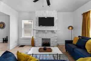 a living room with a blue couch and a fireplace at Modern Hyde Park HydeOut (FL1) in Kansas City