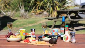 a table with wine glasses and food and wine bottles at Moomba Holiday and Caravan Park in Port Sorell