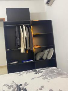 a black book shelf next to a bed at CALENA I in San Lorenzo