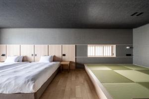 Postel nebo postele na pokoji v ubytování Villa JacoO-ヴィラじゃこまる-