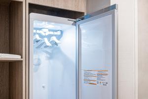 einen Kühlschrank mit offener Tür in der Küche in der Unterkunft Gyeongju Poverta Hotel in Gyeongju