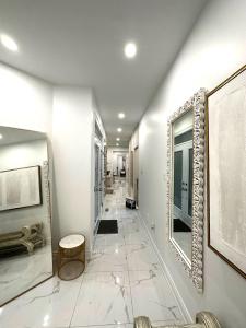 a hallway with white walls and a mirror and a hallway with a hallway at Luxury Home in Toronto (Mississauga) in Mississauga