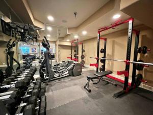 a gym with several treadmills and machines in it at Large 5BR Retreat - Hot Tub - Gym - Games - I-25 in Castle Rock
