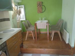a kitchen with a table and chairs in a room at The Loft Beyond The Sea, 3 storey Residence, 67 Mandilara in Kos Town