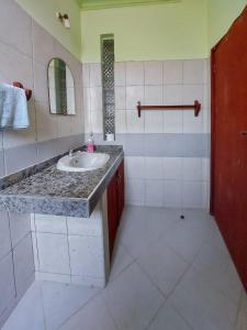 a bathroom with a sink and a mirror at tulia liqizo homestay in Mombasa