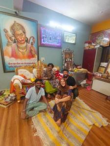 a group of people sitting on the floor in a room at Backpackers Karma Home stay in Khajurāho