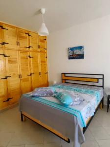 a bedroom with a bed with pillows on it at Ghar el melh in Ghār al Milḩ