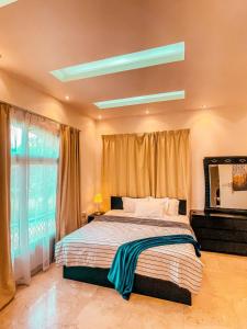 a bedroom with a large bed and a large window at Villa Room #3 in Umm Al Sheif in Dubai