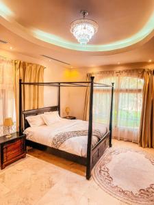 a bedroom with a bed and a chandelier at Villa Room #3 in Umm Al Sheif in Dubai