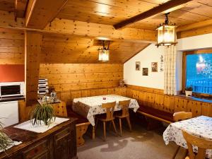 a dining room with a table and a bench at Residence Zirmer Wohnung Erde in Castelrotto +24 photos