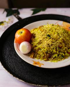 a plate of rice and an apple on a table at Elefantastic in Jaipur