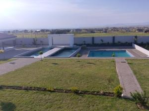 an aerial view of a backyard with two pools at Dudsk Enyonini in Newcastle