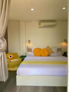 a bedroom with a bed with a stuffed animal on it at 17Stories in Pai
