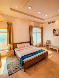 a bedroom with a large bed in a room at Villa Room #6 in Umm Al Sheif in Dubai
