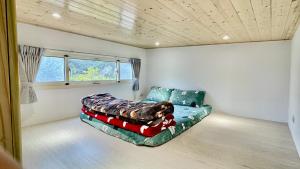 ein Schlafzimmer mit einem Sofa in einem Zimmer mit einem Fenster in der Unterkunft The house behind stream in Dahu