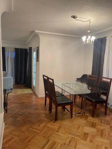 a dining room with a glass table and chairs at Home in West Vancouver in West Vancouver +5 photos