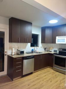 an empty kitchen with wooden cabinets and appliances at Home in West Vancouver in West Vancouver